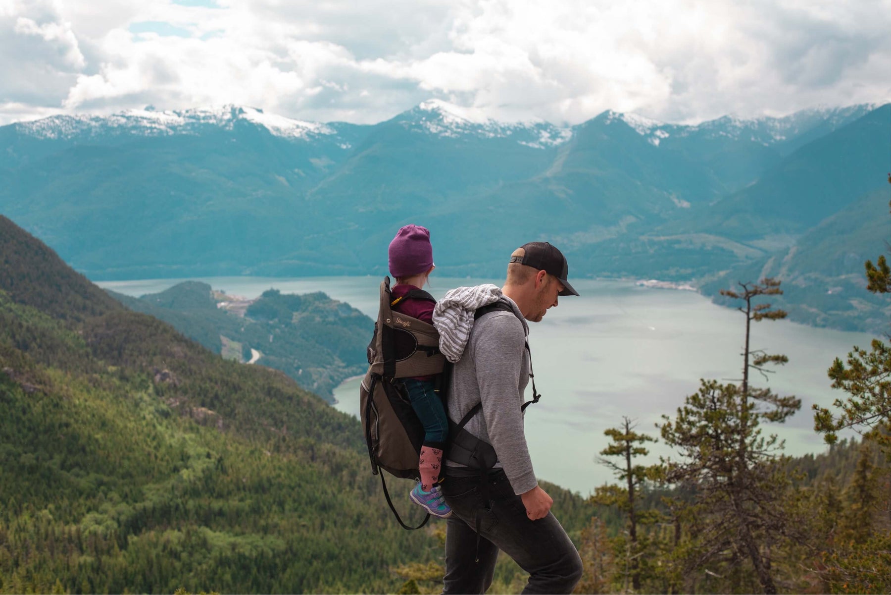 Father and daughter hiking during the fall in Colorado overlooking a lake