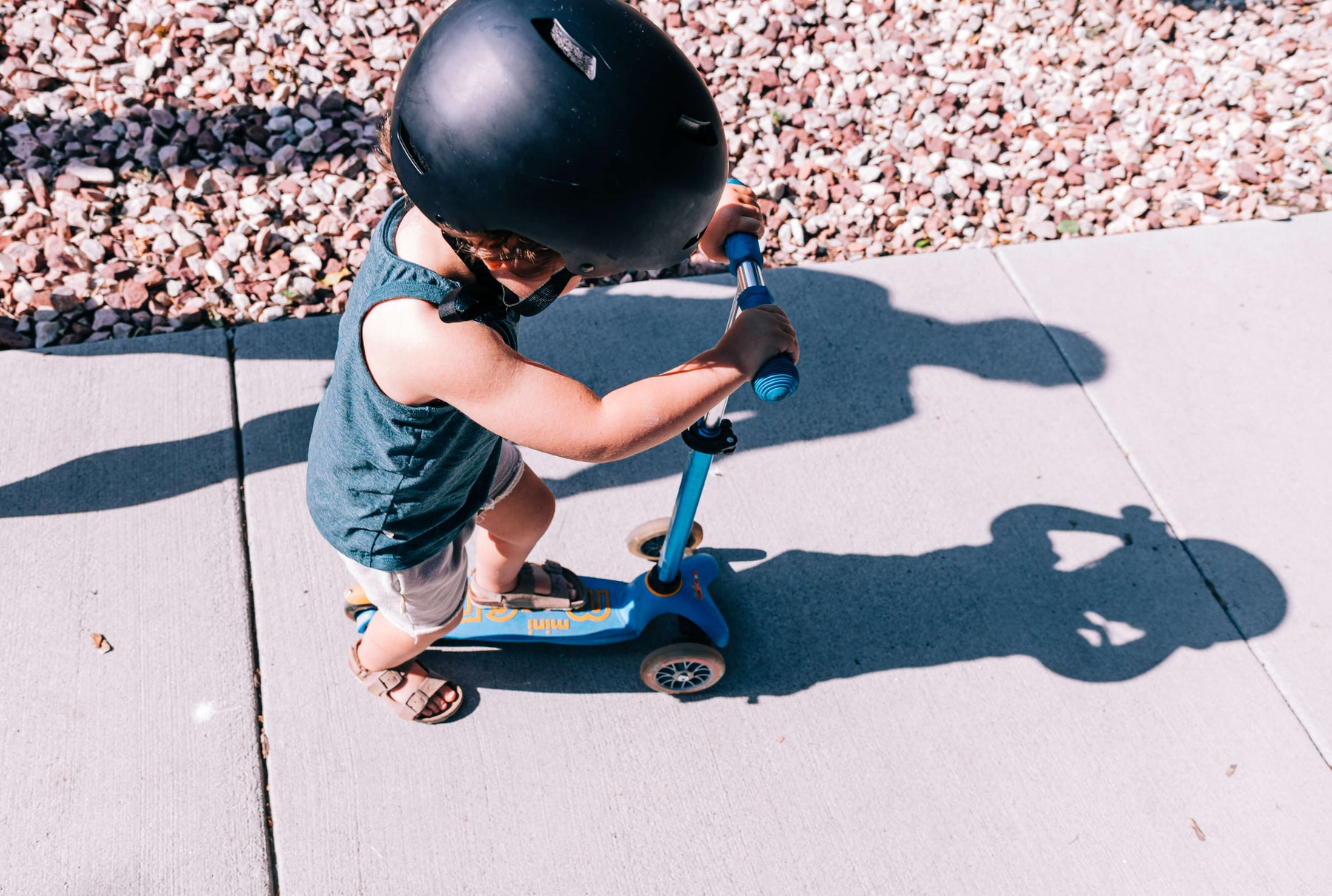 kid riding a scooter outdoors 