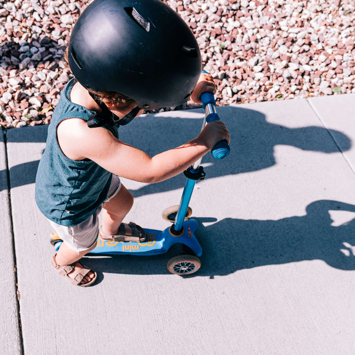 kid riding a scooter outdoors 