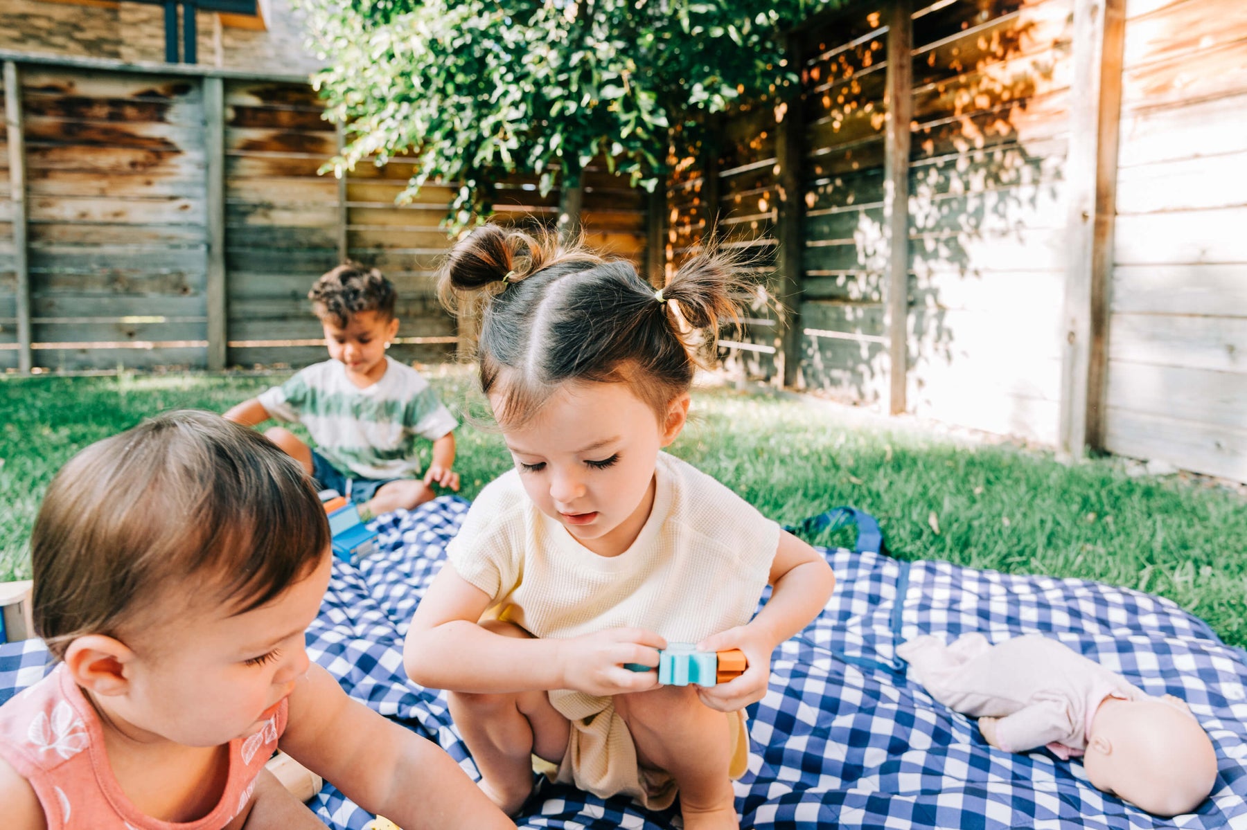 kids playing outside with wooden toys