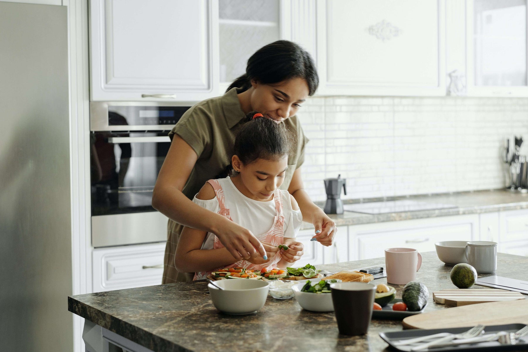 Mom making lunch with her toddler