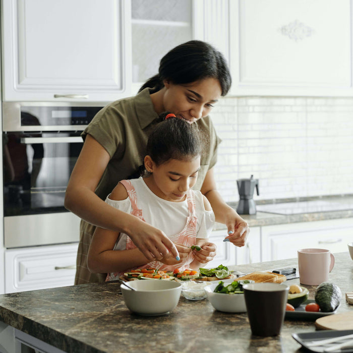 Mom making lunch with her toddler